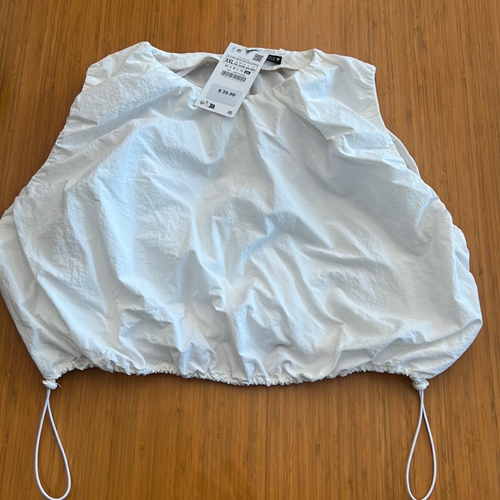 White crop top new never worn has zipper in back and ties at the bottom